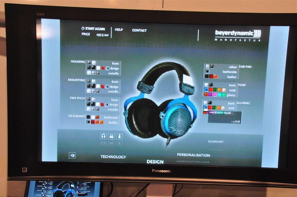 A Panasonic television displaying a customization menu for headphones with various options for materials, colors, and parts. There is a large image of a headphone set on the right and the menu options on the left with the total price displayed at the top.