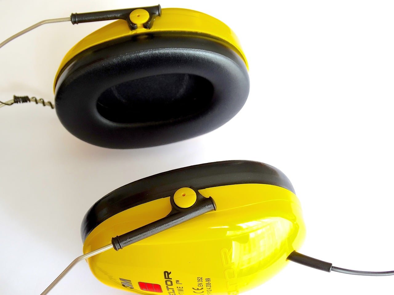 A pair of yellow and black over-ear hearing protectors on a white background.