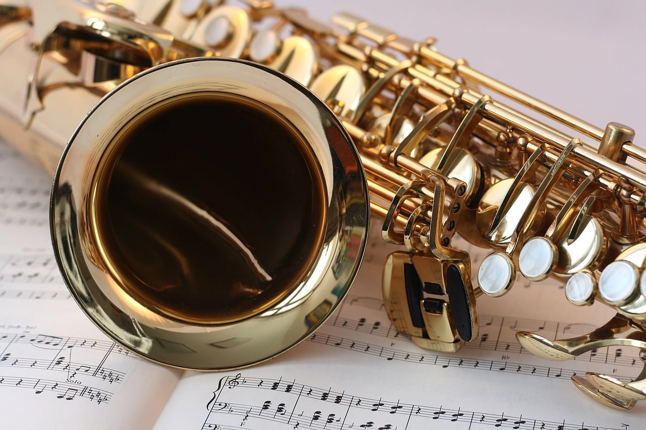 A saxophone lying on sheet music.